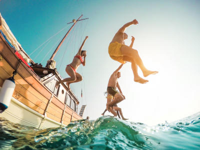 People jumping off a boat into the water