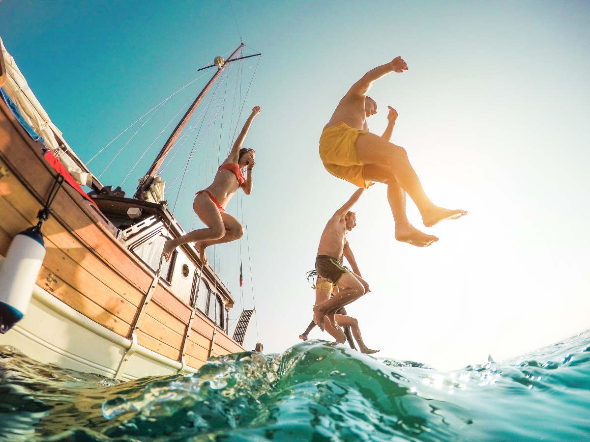 People jumping off a boat into the water